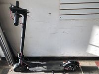 Full side view of black Hiboy electric scooter standing upright
