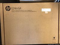 Front of the sealed cardboard box showing HP branding and model details for E24m G4 monitor.