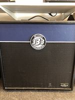Front view of the Jet City guitar speaker cabinet showing its blue tolex covering with black grille cloth and the Jet City 333 Amplification badge.