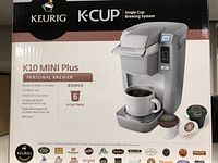 Front of Keurig K10 Mini Plus box showing product image and main features like brewing time under 2 minutes, compact size, and 6 bonus K-Cup packs.