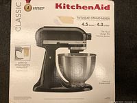 Front of KitchenAid box showing black Classic tilt-head stand mixer, 4.5 qt / 4.3 L capacity, ‘over 10 attachments available’