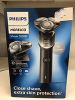 Front side of the Philips Norelco 5000X Series electric shaver box showing the product image, brand name, model, and key features like SkinProtect technology and protective coating.