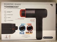Front side of the product box showing the massager and its features like instant heat or cold, whisper quiet, 6 speeds, 6 attachments, ice + heat therapy temperature range.