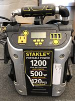 Front view of Stanley Portable Power Station showing control panel with digital display, yellow control buttons, AC outlet, and USB charging ports.