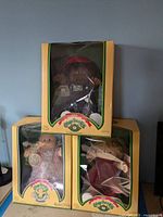 Three boxed Cabbage Patch Kids dolls stacked, showing condition and packaging