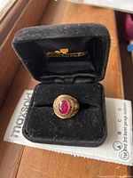 Ring in black velvet Jostens box showing front view