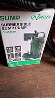 Front of Zoeller submersible sump pump box showing brand, horsepower, flow rate and material