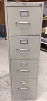 Front view of four-drawer metal file cabinet