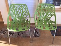 Front view of two lime green cut-out chairs
