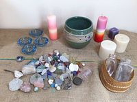 Entire lot laid out showing bowl, beach glass, candles, holders, bottles in basket