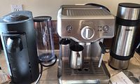 Breville espresso machine, Nespresso Vertuo machine, empty reservoir and Thermos bottle