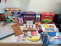 Overall lot showing boxed board games, model kit, card decks, toys