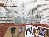 Overall view of lot displaying framed pieces, torsos, mask, vessel, grid panel, twig shelf