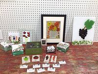 Group shot of fused glass floral frame, grape panel, three boxes, miniature frame, vegetable tiles and herb markers
