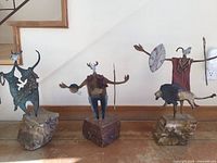 All three shaman sculptures on stone bases