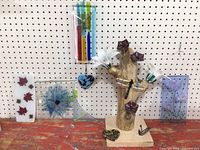 All glass pieces arranged along pegboard and wood table