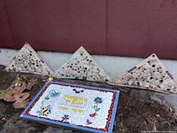 Rectangular mosaic plaque, three triangular panels, metal frog