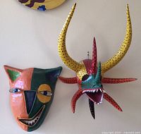 Two masks on wall showing overall view