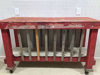 Front view of red rolling work table showing dividers