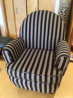 Front view of striped armchair showing curved back and arms