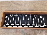 Open display case showing aluminum chess pieces