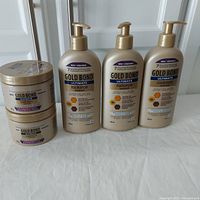 Photo of 2 round containers of Gold Bond Ultimate Radiance Renewal Whipped Shea Butter Body Butter and 3 pump bottles of Gold Bond Ultimate Radiance Renewal Hydrating Lotion.