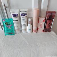 Full lot display showing all 7 hair care products in packaging including Mane Club, Marc Anthony, Coco & Eve, Monday, and L'Oreal Paris.