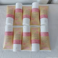 Top view of all 10 tubes of Cake Heavy Cream Hand Balm arranged on a white surface.