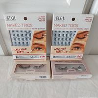 Full lot showing two Ardell Naked Trios packages, Ardell Smitten lashes and Ardell Bombshell lashes in their boxes.
