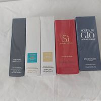 Five sealed travel-size fragrance boxes in original cellophane.