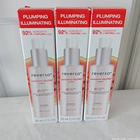 Front view of three boxed Reversa radiance-GLOW creams, showing label and volume.