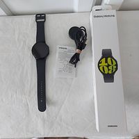 Watch, charger dock, USB cable, manual and original box laid out