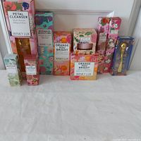 Photo showing all Winky Lux products lined up in their boxes with colorful floral and marine-themed packaging.