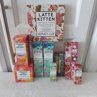 Full lot image showing all 10 boxed cosmetic products arranged on a flat surface