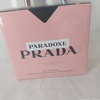 Front view of the Prada Paradoxe pink textured box showing branding and size.