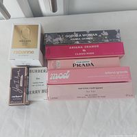 Eight boxed travel fragrances arranged on surface