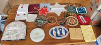 Photo of the entire lot arranged on a wooden table showing different kitchen textiles and trivets.