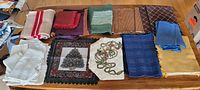 Overview of 13 placemats showing a variety of colors and styles including embroidered and patterned pieces.