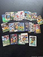 Image showing 19 football cards featuring Torry Holt in various poses and uniforms, arrayed on a dark background.