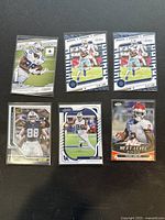 Six 2020 Panini sports cards including multiple CeeDee Lamb Dallas Cowboys cards and one Clyde Edwards-Helaire Chiefs card.