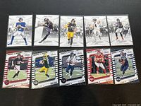 Photo showing 10 NFL trading cards from Panini Prestige 2023 collection arranged in two rows on a black surface.
