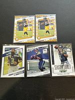 Front view of five Russell Wilson football cards featuring Pittsburgh Steelers and Seattle Seahawks with action shots and clear player images.