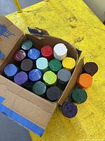 Open box containing assorted colour Rust-Oleum Painter's Touch spray paint cans