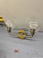 full view of fixture assembled with glass shades attached and mounting screws visible