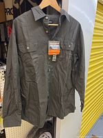 Front view of olive green work shirt with tags attached