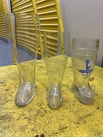 Front view of three glass boot mugs