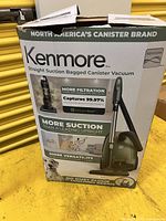 Retail carton front displaying Kenmore 400 Series straight suction bagged canister vacuum