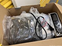 Fryer components inside box with protective plastic