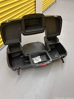 Open view of QuadBoss cargo box showing dual storage compartments, center compartment and included mounting hardware