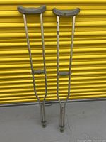 Full front view of both crutches standing upright